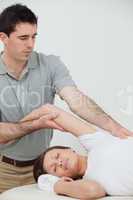 relaxed woman being stretched by a physiotherapist