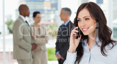 Businesswoman talking on the phone in a relaxed way with her tea