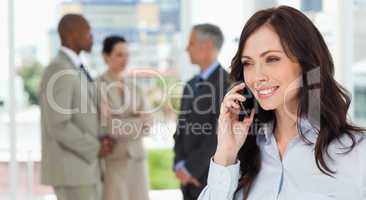 Businesswoman talking on the phone in a relaxed way with her tea