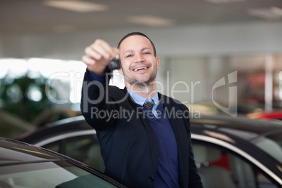 Salesman standing while holding car keys