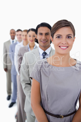 Close-up of colleagues in a single line smiling and looking stra