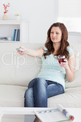 Woman pressing a remote control