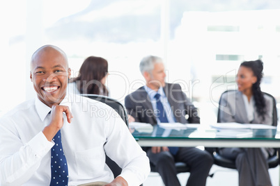 Confident manager laughing while looking at the camera with his