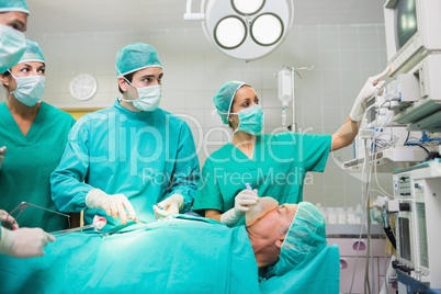 Surgical team looking at a monitor