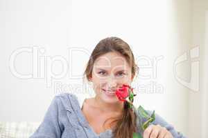 Woman holding a rose while smiling