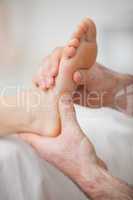 Foot receiving a massage by a physiotherapist