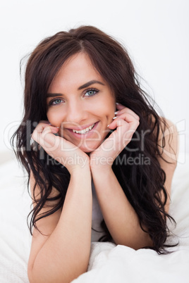 Cheerful brunette woman lying on her blanket