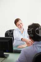 Businesswoman shaking hand to her client