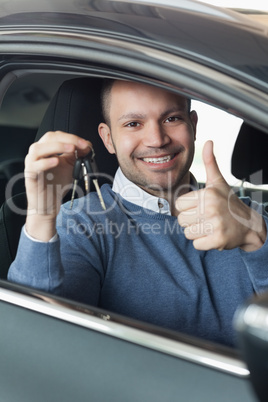 Smiling man holding car keys