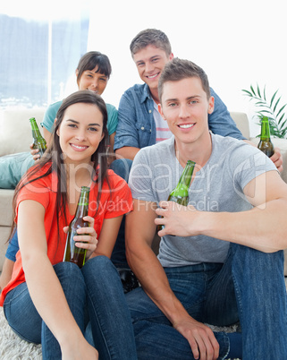 Two people sitting on the couch with the other two sitting on th