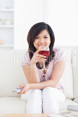 Woman smiling and holding a glass of red wine