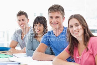 Four people looking at the camera