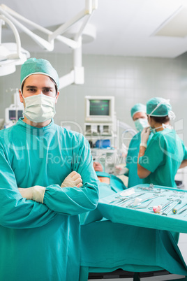 Surgeon looking at camera with arms crossed