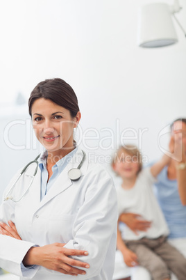 Smiling doctor looking at camera with arms crossed