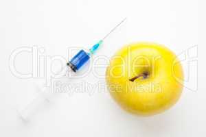 Apple next to a syringe