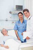 Patient with her doctor and nurse looking at camera