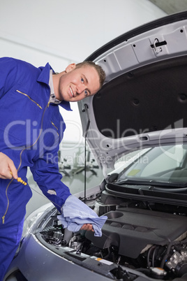 Mechanic holding a dipstick