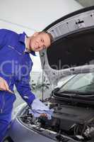 Mechanic holding a dipstick