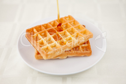 Honey falling on a waffle