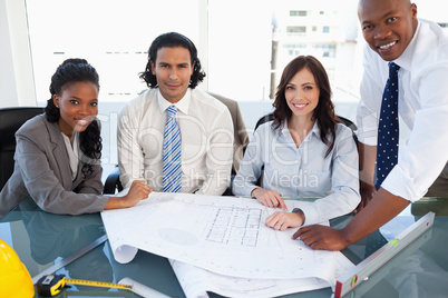 Smiling business team working on a project in a meeting room