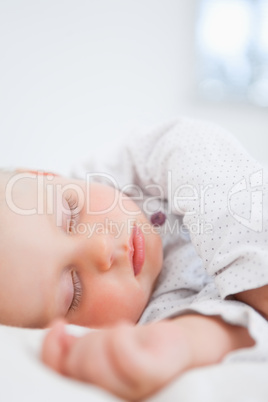 Baby sleeping while extending her arm