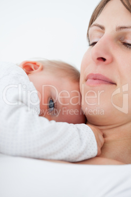 Peaceful baby lying on the chest of her mother