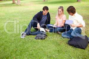 High angle-shot of three students in a park