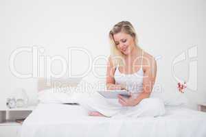 Blonde using an ebook while sitting