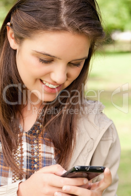 Close-up of a cute teenager using a smartphone