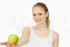 Woman smiling while holding an apple