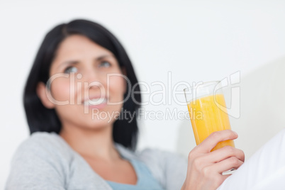 Woman holding a glass of orange juice