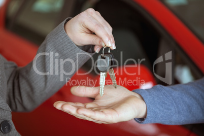 Person handing keys to someone else