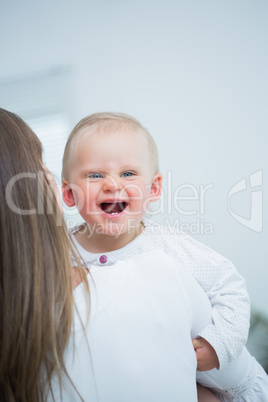 Mother holding a baby on his arms