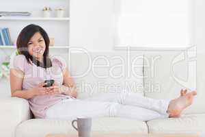 Woman smiling and lying on a couch