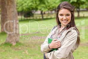 Portrait of a young student holding textbook