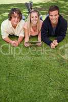 Portrait of three young people using a tactile tablet