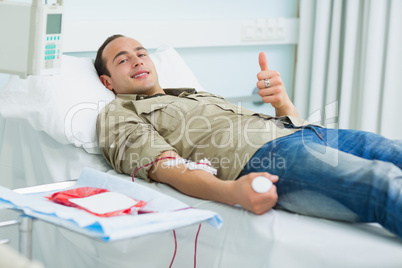 Smiling transfused patient lying on a bed