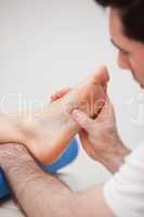 Reflexologist massaging the foot of his patient