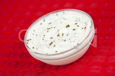 Bowl of white dip on a red tablecloth