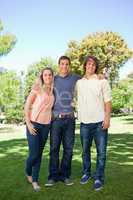 Three smiling students standing