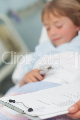 Focus on medical result next to a child