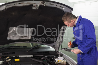Mechanic holding a clipboard