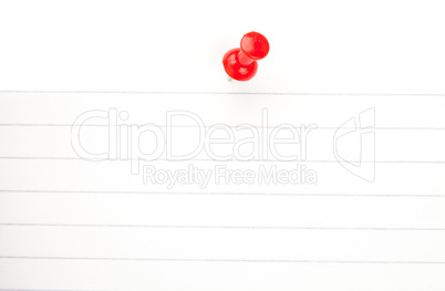 Red pushpin with a white paper