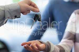 Car dealer giving keys to a customer