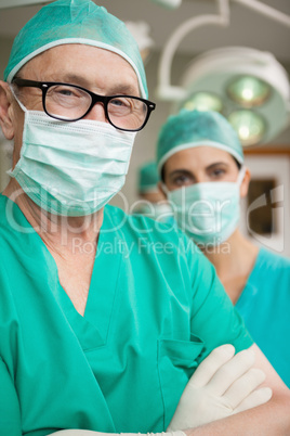 Surgeon crossing his arms with a colleague