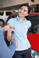 Smiling woman shaking the hand of a man