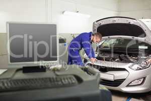 Mechanic examining a car engine