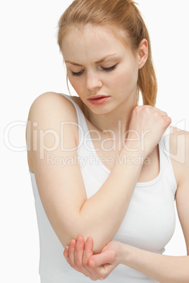 Woman touching her elbow