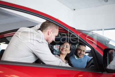 Couple in a car listening to a salesman
