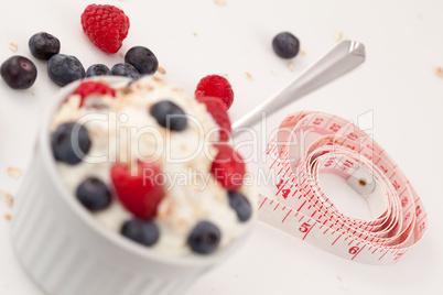 Tape measure and a dessert of berries